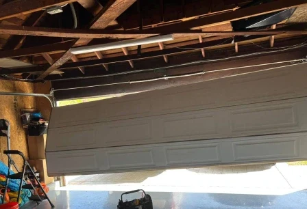 Off-track door repaired — before